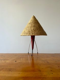 a table with a lamp on it that is sitting on top of a wooden floor