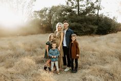 a family posing for a photo in a field