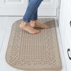 a person standing on a door mat with their feet propped up in front of the door