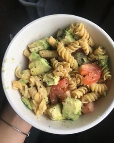 a white bowl filled with pasta and vegetables