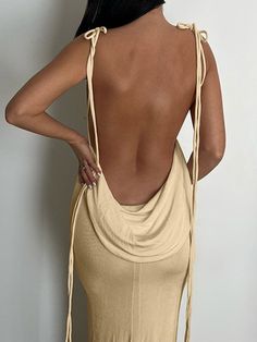 the back of a woman wearing a tan dress