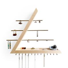 a wooden shelf with several pairs of earrings hanging from it's sides and hooks on the bottom