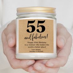 a person holding a jar with the number 55 and fabulous birthday message