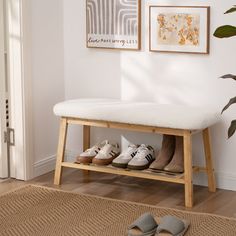 a pair of shoes are sitting on a bench in front of a wall with pictures