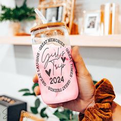 a person holding up a pink drink in a glass jar with the words great memories on it