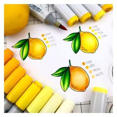 some crayons and markers are sitting on top of a paper with lemons