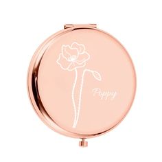 a compact mirror with a flower drawn on it's front and the words happy written in white ink