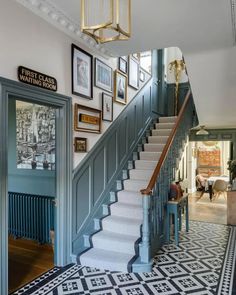 the stairs in this house have been painted blue and are decorated with pictures on them