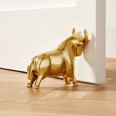 Decorative gold door stopper holds steady-no bull. Press flat side with horns up against the door for full support; equally sharp as a bookend. CB2 exclusive.  -Aluminum gold tinted body -Iron weight inside -6.6 lbs/2.97 kg -Clean with soft cloth -Made in India Pascal The Bull Gold Doorstop-Bookend. Polo Mallet Decor, Book Ends Aesthetic, Farmette Ideas, Over Door Decor, Door Support, Lotus Flower Candle Holder, Modern Desk Accessories, Wood Pillar Candle Holders, Modern Decorative Objects