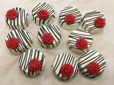 nine decorated chocolates with red roses on them