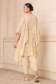 Buy Beige Embroidered Chikankari Notched Kaftan Tunic And Dhoti Pant Set For Women by Tarun Tahiliani Online at Aza Fashions. Eid Palazzo Set With Dupatta And Cape Sleeves, Beige Georgette Sets With Traditional Drape, Beige Festive Kurta With Traditional Drape, Transitional Beige Set With Traditional Drape, Beige Kurta With Zari Work In Traditional Drape, Beige Traditional Drape Dress For Diwali, Traditional Drape Beige Dress For Diwali, Transitional Wedding Kaftan With Traditional Drape, Anarkali Embroidered Palazzo Set With Tunic