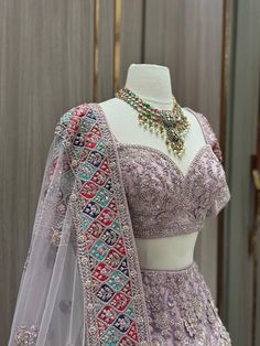 Our Mauve Purple Luxury Collection Bridal Wear Lehenga BWL-159 will make you feel like royalty on your special day. This elegant lehenga features a luxurious mauve and purple embroidered design perfect for any wedding, with intricate beading and delicate handiwork to create a timeless look. Its luxurious fabric is soft and comfortable, making this piece a perfect choice for a grand entrance. Complemented with Similarly embroidered blouse and net dupatta. Fabric: Net with raw silk lining WASH CAR