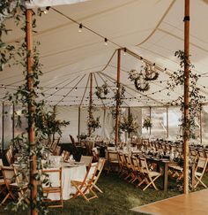 an outdoor tent set up with tables and chairs