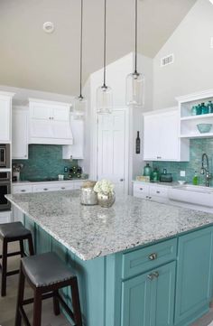 a kitchen island with two stools in front of it