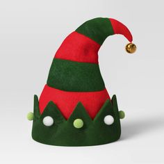 Whether you're dressing up for a holiday party or just looking to add instant festive flair to your everyday look, this Striped Christmas Elf Costume Hat with Bell from Wondershop™ is the perfect accessory. Made of polyester, this red-and-green striped elf hat is trimmed with a decorative cuff featuring fluffy pompoms in light green and white and is topped with a gold jingle bell. Perfect for Christmas parties, parades, or family gatherings, this elf hat will add a touch of festive cheer whereve Red Christmas Hat For Festive Occasions, Christmas Tree Headband, Elf Accessories, Christmas Elf Costume, Antler Christmas, Xmas Dress, Hat Patterns To Sew, Accessory Ideas, Elf Costume