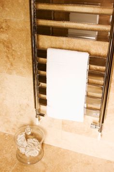 a towel rack in a bathroom next to a radiator