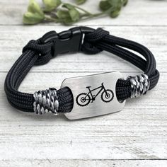 "Mountain Bike Adventure bracelet.. rugged and fashionable bracelet, goes wherever your adventures take you! Create a fashion statement hiking the trails, paddling the rivers, a night on the town, or just a day at the office! durable parachute style cord with wrap side accents. Side release durable acrylic clasp, easy on and off Brushed Stainless steel UP cutout charm with deep etched bike image Non tarnish stainless steel Wear biking, or just as a fashion statement Washable, durable military gr Durable Adjustable Bracelet For Outdoor, Adjustable Durable Bracelet For Outdoor, Casual Outdoor Bracelet, Casual Black Braided Bracelets For Outdoor, Durable Nylon Cord Bracelets For Outdoor, Adjustable Silver Bracelet For Outdoor, Adjustable Black Bracelets For Outdoor, Adjustable Nylon Cord Braided Bracelets For Outdoor, Adjustable Black Braided Bracelet For Outdoor