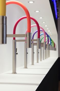 there are many different colored handles on this display wall in the store or showroom