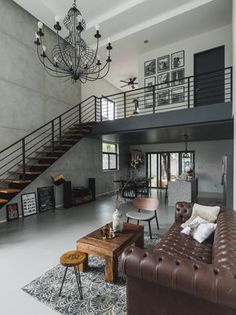 a living room filled with furniture and a staircase