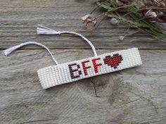 a beaded ornament with the word eff hanging from it's side