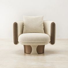 a chair with a pillow on it sitting in front of a white wall and floor