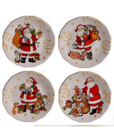 four christmas plates with santa clause on them