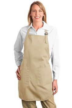 a woman wearing an apron and smiling at the camera with her hands on her hips