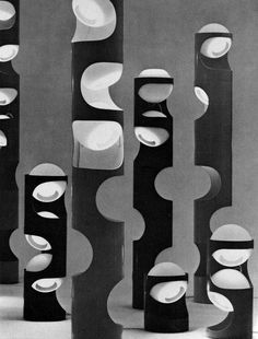 black and white photograph of abstract sculptures in an art gallery, with circles on them