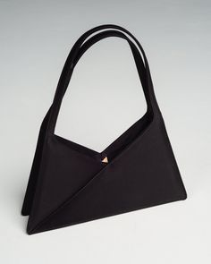 Accordion baguette bag by MM6 Maison Margiela. A reinterpreted style based on Maison Margiela's signature triangle bag range. Crafted with sleek satin to a concise, angular silhouette. Accordion gusset allows for deceptively spacious capacity. 50% Cotton, 50% Polyester.Made in Italy. Designer Evening Baguette Bag With Top Carry Handle, Designer Baguette Bag With Top Carry Handle For Evening, Modern Triangle Bag With Detachable Strap, Formal Rectangular Baguette Bag With Dust Bag, Elegant Baguette Bag With Removable Pouch For Formal Occasions, Elegant Baguette Bag With Top Carry Handle, Formal Rectangular Baguette Bag, Chic Evening Baguette Bag With Magnetic Closure, Chic Baguette Bag For Evening