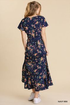 This feminine floral maxi dress is your ticket to a magical summer escape. Its breezy wrap silhouette and ruffle sleeves channel carefree boho vibes, while the vibrant floral print summons visions of sunny meadows and fragrant blooms. Made of a lightweight [poly] blend, it's perfect for balmy days and steamy nights. Whether you're dancing barefoot at an outdoor music festival or strolling the beach at sunset, this whimsical wonder will make every moment feel like an adventure. Pair it with strap Flowy Summer Wrap Dress With Flutter Sleeves, Flowy Maxi Length Floral Dress, Blue Ditsy Floral Print Maxi Dress For Garden Party, Flowy Maxi Floral Dress For Garden Party, Spring Flowy Wrap Dress With Flutter Sleeves, Spring Wrap Dress With Flutter Sleeves, Spring Beach Maxi Dress With Flutter Sleeves, Spring Flutter Sleeve Wrap Dress For Brunch, Fitted Flutter Sleeve Maxi Dress For Vacation