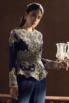 Blue peplum top with floral embroidered motifs and cutwork detail. Paired with layered sharara.
Component: 2
Embroidered
Neckine: Round
Sleeve Length: Full
Fabric: Crepe
Color: Blue
Dori and zardosi embroidery
Layered sharara
Cutwork detail - Aza Fashions Elegant Chikankari Embroidered Top For Wedding, Elegant Festive Top With Chikankari Embroidery, Elegant Sharara With Floral Embroidery And Peplum, Elegant Floral Embroidered Sharara With Peplum, Elegant Peplum Sharara With Floral Embroidery, Elegant Floral Embroidered Peplum Sharara, Elegant Embroidered Peplum Sets, Elegant Blue Blouse With Chikankari Embroidery, Blue Embroidered Top For Reception