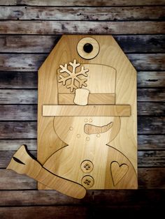 a wooden cutting board with an image of a snowman on it