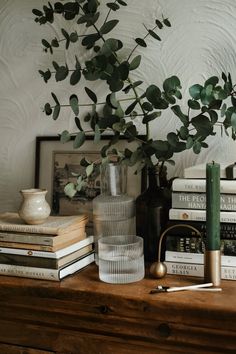 some books and vases sitting on a table