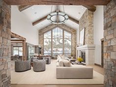 a living room filled with furniture and a stone fireplace