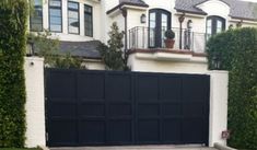 a large white house with a black garage door