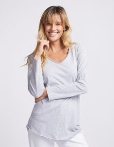 DESCRIPTION Have you been looking for the perfect trans-seasonal t-shirt? Look no further than the Original V-Neck Long Sleeve T-Shirt from White & Co. Designed to be the tee that you know you can reach for to look stylish and comfortable! Crafted from ultra-soft cotton jersey, this stylish women's t-shirt features a V-neckline, long sleeves and a flattering scoop hem. We are sure you are going to want one of these in every colour! Wear it with everything from jeans to skirts, this everyday essential is the perfect foundation for any outfit. Still browsing? See our full range of women's clothing. FEATURES & FIT V-neckline Long sleeve Curved hemline Raw edge on sleeve and hem Cotton Designed in Melbourne Fit: Relaxed fit. Model is 171cm tall and wears a size 8(AU)/4(US). Model (brunette) is Cotton V-neck T-shirt For Layering, Gray Relaxed Fit V-neck Top, Basic Fall Loungewear T-shirt, Gray V-neck T-shirt For Fall, Heather Grey Stretch Top For Loungewear, Basic Gray V-neck Tops, Basic Long Sleeve T-shirt For Loungewear, Basic Gray Tops For Loungewear, Basic Scoop Neck Top For Loungewear