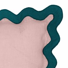 a blue and pink placemat with an oval shape on it's side, in the center