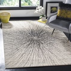 a living room with a chair and rug in it