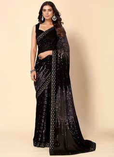 Product Features: Saree Color: Black Blouse Color: Black Saree Fabric: Georgette Blouse Fabric: Dupion Saree Work: Sequins Work Saree Type:Woven Saree Border: Lace Border Pallu Style: Fancy Pallu Wash Care: Dry Clean Occasion: Party wear Product Type: Saree Disclaimer: There will be slight difference in digital to actual image Festive Black Pre-draped Saree With Self Design, Festive Black Pre-draped Saree With Cutdana, Black Sequined Pre-draped Saree, Black Blouse Piece With Zari Work For Eid, Black Zari Work Blouse For Eid, Elegant Black Saree For Eid, Black Pre-draped Saree With Pallu For Festive Occasions, Black Blouse Piece For Wedding Eid, Black Blouse Piece For Wedding And Eid