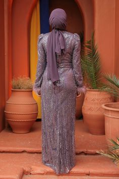 This stunning evening dress is crafted with intricately sequined fabric, creating a dazzling and luxurious look. Perfect for any formal occasion, this dress is a must-have for the modest woman wanting to make a statement. With its elegant design and versatility, it can be paired with a variety of hijab styles for a truly unforgettable look. Elevate your wardrobe with this opulent prom dress and make a lasting impression. Modest Woman, Abaya Black, Sequined Fabric, Beaded Fabric, Evening Jumpsuit, Hijab Styles, Long Evening Dress, Abaya Dress, Maxi Dress Formal