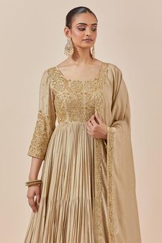 Beige chanderi silk full length anarkali with zardozi and sequin floral embroidery. Comes with embroidered border dupatta.
Components: 2
Pattern: Embroidered
Type Of Work: Floral Pattern
Neckline: Round
Sleeve Type: Straight Three Quarter
Fabric: Chanderi Silk
Color: Beige
Other Details: 
Attached lining
Back scoop neck
Tiered anarkali
Approx. product weight (in kgs): 2.5
Occasion: Wedding,Sangeet - Aza Fashions Chinon Anarkali Set For Reception With Straight Kurta, Raw Silk Anarkali Set For Reception And Festivals, Anarkali Silk Gown With Resham Embroidery, Anarkali Style Reception Traditional Wear In Chinon, Anarkali Dola Silk Set Floor-length, Anarkali Floor-length Set In Dola Silk, Floor-length Anarkali Set In Raw Silk, Floor-length Anarkali Set In Dola Silk, Gold Chanderi Gown With Cutdana Detail