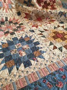 a large quilt is laying on the bed