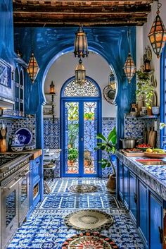 an ornate kitchen with blue and white tiles on the walls, flooring and cabinets