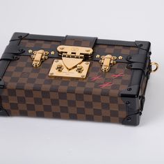 A truly unique piece from Louis Vuitton, the Petite Malle was inspired by trunks originally created in the early 20th century for elite banker Albert Kahn. Carefully crafted from classic LV monogram canvas with black leather trimmings, romantic gold tone hardware, and three red cross detailing - the Petite Malle is a must-have for any luxury lover. The perfect option to accessorize any outfit from day to night, this piece will compliment pretty much anything you have in your wardrobe. Designed for any modern woman with a fashion forward sense of style and a love for timeless pieces with a contemporary edge. SPL Exterior Louis Vuitton Damier Ebene printed canvas Black calfskin trim Gold tone hardware S-lock close Removable leather shoulder strap Brand new and unused Interior Beige lining Sp Louis Vuitton Petite Malle, Lv Monogram, Louis Vuitton Damier Ebene, Dior Shoes, Printed Canvas, Damier Ebene, Red Cross, Embossed Logo, Chanel Handbags