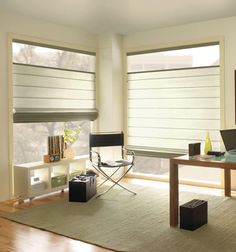 a living room filled with furniture and windows covered in roman blind shades on top of them