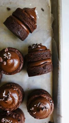 chocolate cupcakes with frosting on a baking sheet