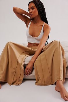 An ultra-wide silhouette takes these casual lounge pants from sleep to street in effortless style. **Fit:** Mid-rise, oversized, semi-cropped **Features:** Comfy cotton blend, elastic waistband, contrast seamed details, ultra wide-leg design, drop crotch style **Why We | In The Moment Wide Leg Pants by Intimately at Free People in Tan, Size: M Relaxed Wide Leg Sleepwear With Elastic Waistband, Cotton Wide Leg Sleepwear, Trendy Relaxed Fit Sleepwear For Lounging, Spring Wide-leg Lounge Sleepwear, Trendy Oversized Loungewear Pants, Relaxed Stretch Wide Leg Pants For Loungewear, Relaxed Fit Wide-leg Sleepwear Pants For Lounging, Chic Cotton Sweatpants For Lounging, Relaxed Fit Wide-leg Sleepwear Pants For Loungewear