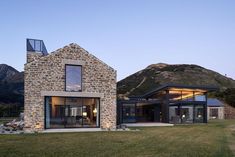 the house is made out of stone and glass