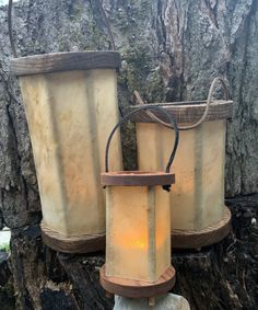 two old fashioned lanterns sitting on top of a tree