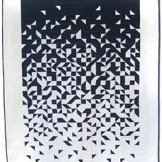 a black and white quilt with triangles on it